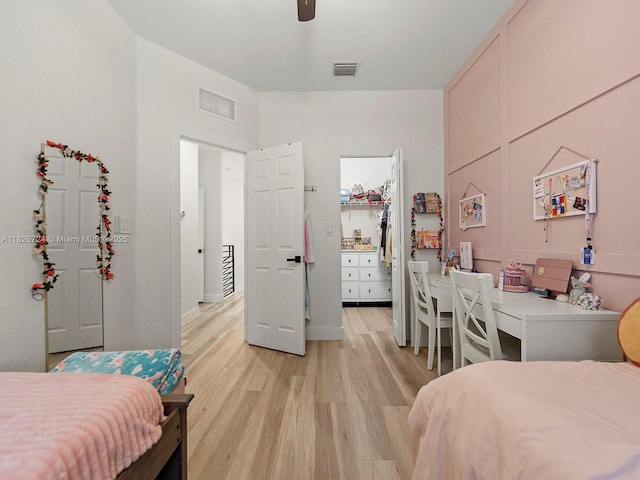 11901 SW 150th Pl, Miami, FL 33196 - bedroom featuring light wood-type flooring, a walk in closet, and a ceiling fan