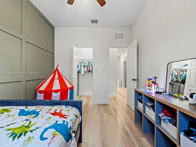 11901 SW 150th Pl, Miami, FL 33196 - bedroom with light wood finished floors, a walk in closet, and ceiling fan