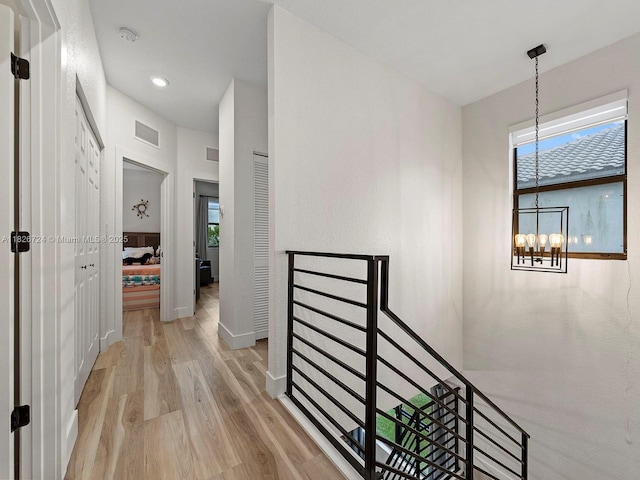 11901 SW 150th Pl, Miami, FL 33196 - hallway with light wood-style flooring, an upstairs landing, a chandelier, and recessed lighting