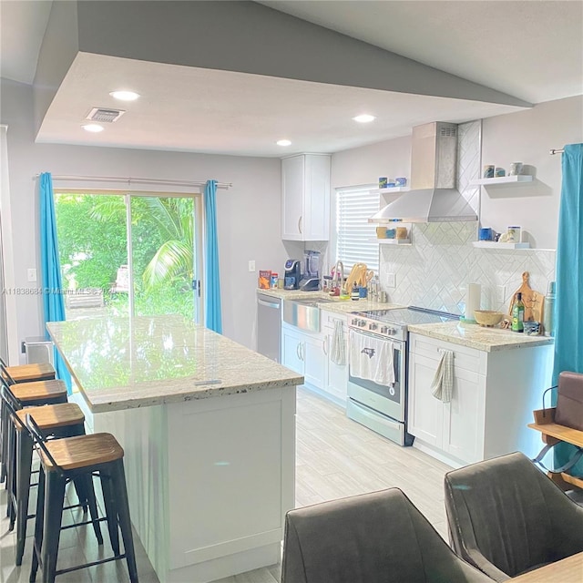 20317 SW 86th Ct, Cutler Bay, FL 33189 - kitchen with stainless steel appliances, wall chimney exhaust hood, open shelves, white cabinets, and a kitchen island