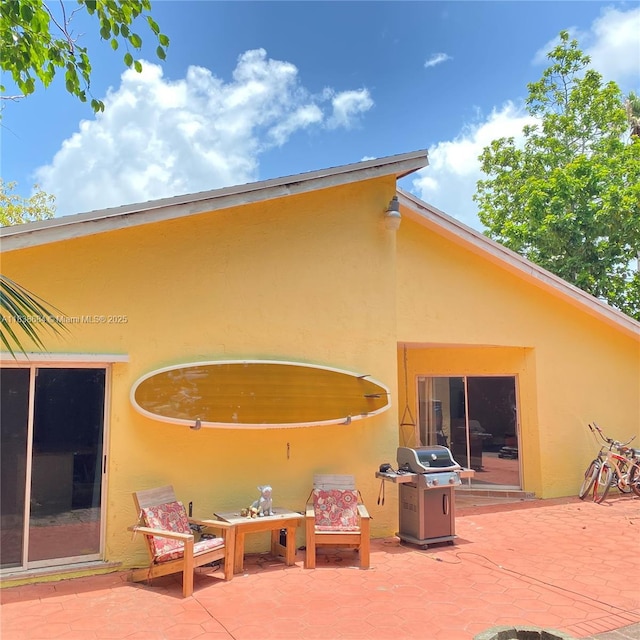 20317 SW 86th Ct, Cutler Bay, FL 33189 - rear view of house featuring stucco siding and a patio