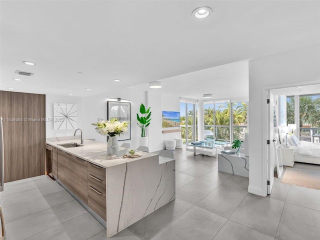 9940 W Bay Harbor Dr Unit 3G-S, Bay Harbor Islands, FL 33154 - kitchen featuring modern cabinets, brown cabinetry, light stone countertops, recessed lighting, and a peninsula