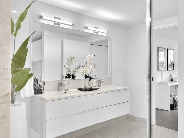 9940 W Bay Harbor Dr Unit 3G-S, Bay Harbor Islands, FL 33154 - bathroom featuring double vanity and marble look tile flooring