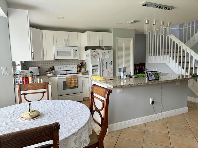 1111 NW 173rd Ave, Pembroke Pines, FL 33029 - kitchen featuring white appliances, light tile patterned floors, white cabinets, light stone countertops, and hanging light fixtures