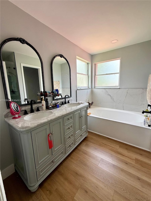 1111 NW 173rd Ave, Pembroke Pines, FL 33029 - bathroom featuring wood finished floors, a garden tub, and double vanity