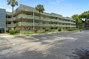 6075 N Sabal Palm Blvd Unit 310, Tamarac, FL 33319 - view of property featuring uncovered parking