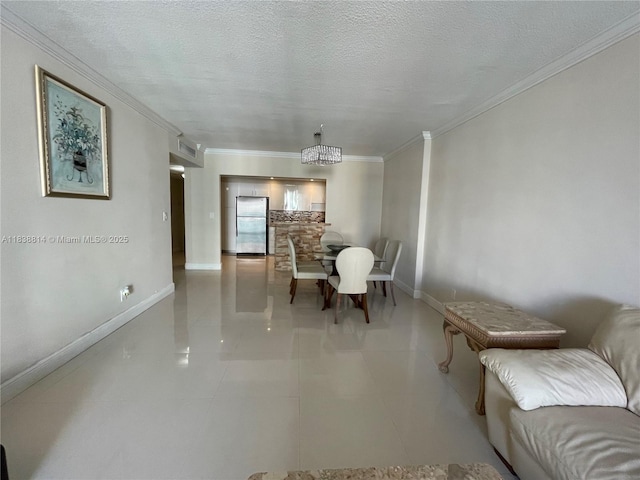 19390 Collins Ave Unit 902, Sunny Isles Beach, FL 33160 - dining area with ornamental molding, light tile patterned flooring, and a textured ceiling