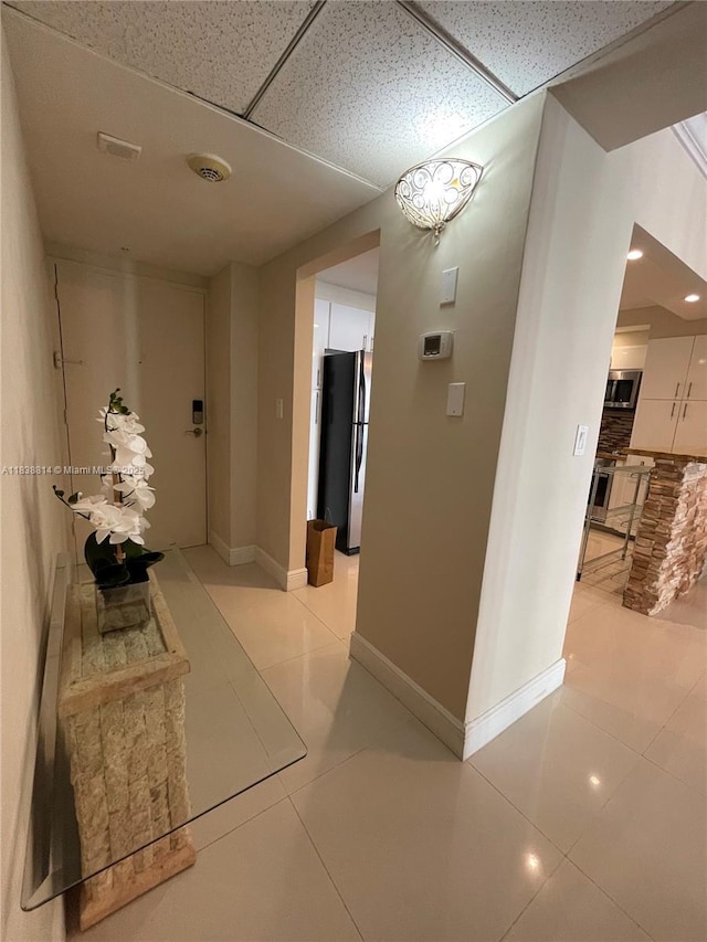 19390 Collins Ave Unit 902, Sunny Isles Beach, FL 33160 - hall with light tile patterned floors and a paneled ceiling