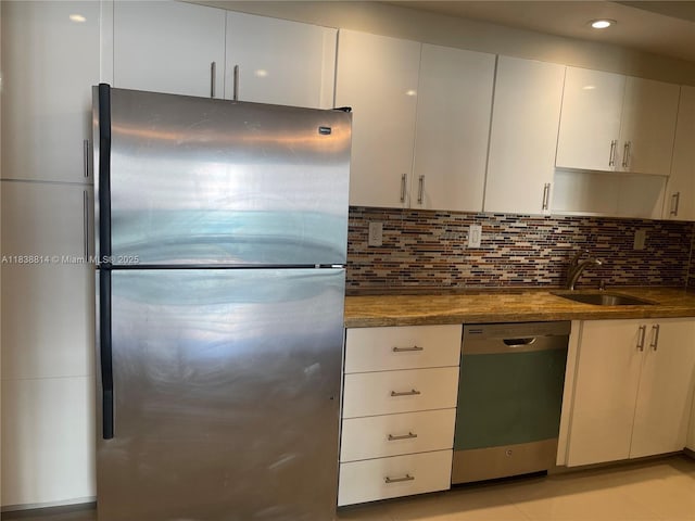 19390 Collins Ave Unit 902, Sunny Isles Beach, FL 33160 - kitchen featuring stainless steel appliances, tasteful backsplash, white cabinetry, recessed lighting, and dark stone countertops