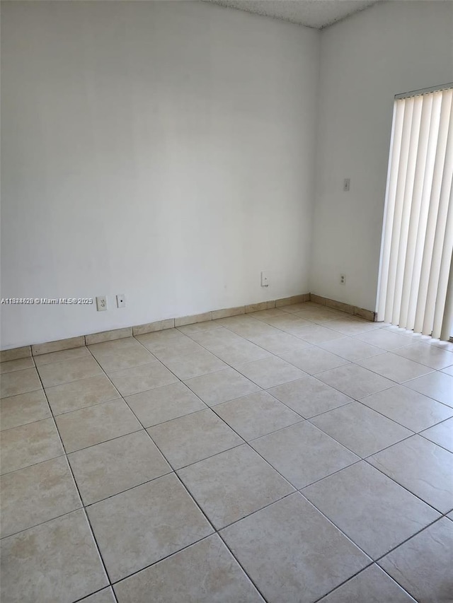 660 Cypress Club Way Unit F11, Deerfield Beach, FL 33064 - spare room with light tile patterned floors and baseboards