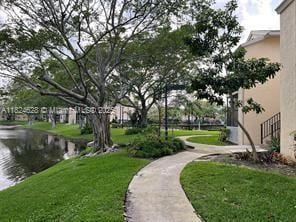 660 Cypress Club Way Unit F11, Deerfield Beach, FL 33064 - view of community with a lawn and a water view