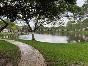 660 Cypress Club Way Unit F11, Deerfield Beach, FL 33064 - surrounding community with a water view and a yard