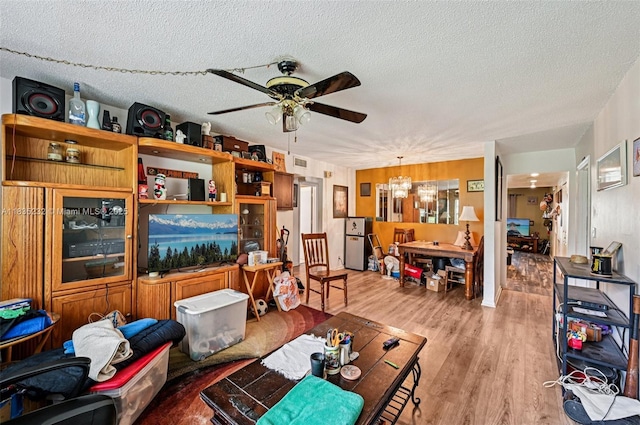 8103 NW 27th St Unit 1, Coral Springs, FL 33065 - living room featuring a ceiling fan, wood finished floors, a chandelier, and a textured ceiling