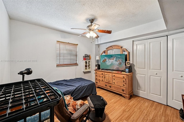 8103 NW 27th St Unit 1, Coral Springs, FL 33065 - bedroom with light wood-type flooring, a textured ceiling, a closet, and ceiling fan