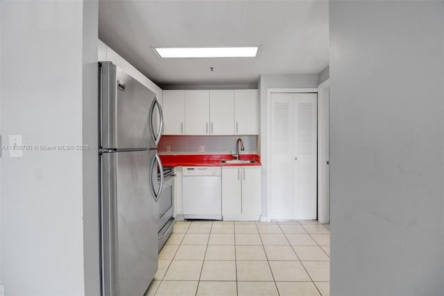 3410 Coral Way Unit 904, Miami, FL 33145 - kitchen with dishwasher, freestanding refrigerator, range, white cabinetry, and light tile patterned flooring