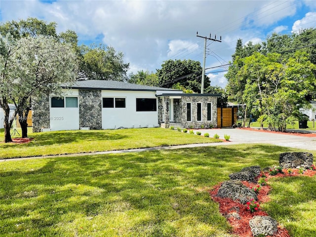 1930 NE 178th St, North Miami Beach, FL 33162 - view of front of property featuring stone siding, a front yard, stucco siding, and driveway