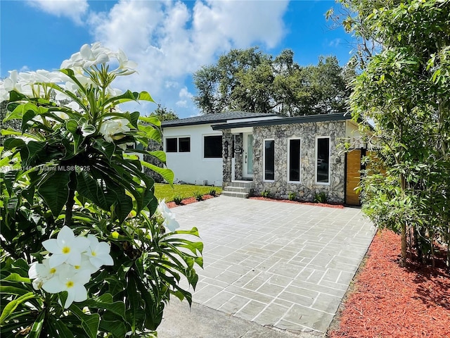 1930 NE 178th St, North Miami Beach, FL 33162 - view of front of property with stone siding