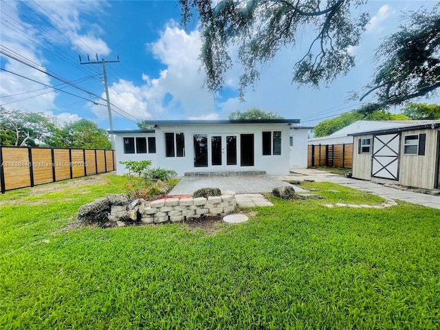 1930 NE 178th St, North Miami Beach, FL 33162 - back of property featuring a storage unit, stucco siding, and a patio