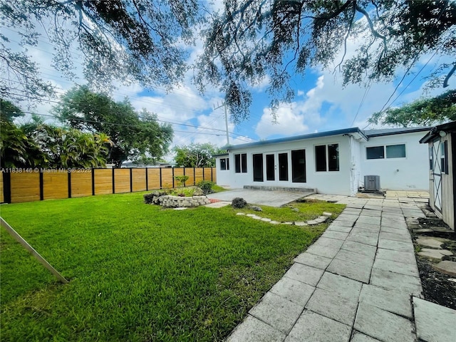 1930 NE 178th St, North Miami Beach, FL 33162 - back of property featuring stucco siding, a patio, and a fenced backyard