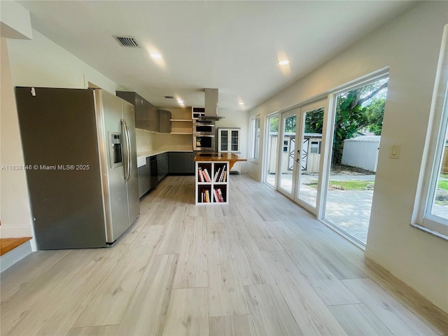 1930 NE 178th St, North Miami Beach, FL 33162 - kitchen with stainless steel refrigerator with ice dispenser, open shelves, french doors, light wood finished floors, and recessed lighting