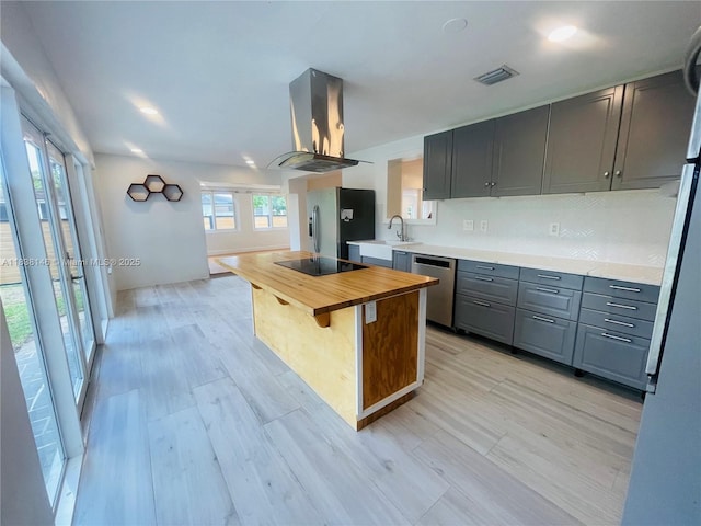 1930 NE 178th St, North Miami Beach, FL 33162 - kitchen with island exhaust hood, appliances with stainless steel finishes, wooden counters, gray cabinetry, and a center island