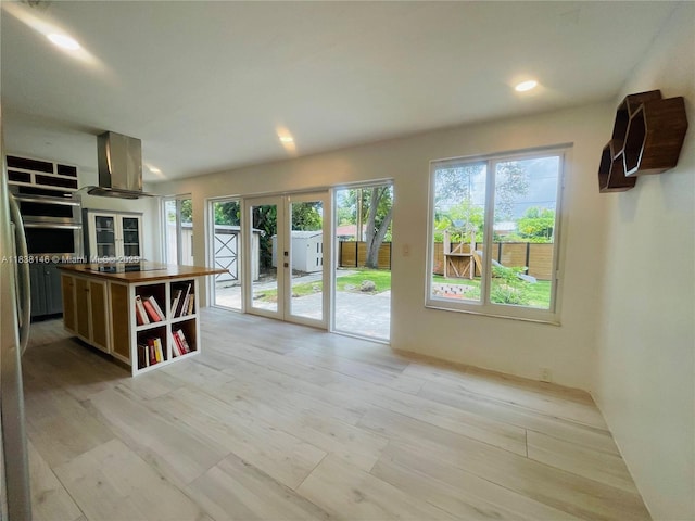 1930 NE 178th St, North Miami Beach, FL 33162 - kitchen with exhaust hood, oven, light wood-style floors, open shelves, and french doors