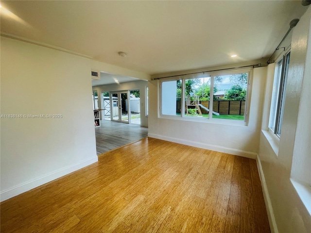 1930 NE 178th St, North Miami Beach, FL 33162 - spare room with wood finished floors, healthy amount of natural light, and recessed lighting