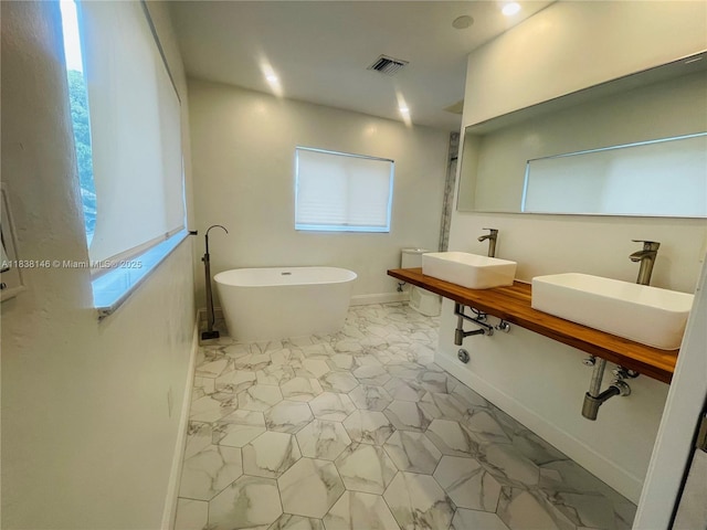 1930 NE 178th St, North Miami Beach, FL 33162 - full bath with marble look tiles, a freestanding tub, and recessed lighting