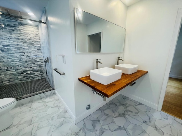 1930 NE 178th St, North Miami Beach, FL 33162 - bathroom featuring marble finish floors, a shower stall, and double vanity