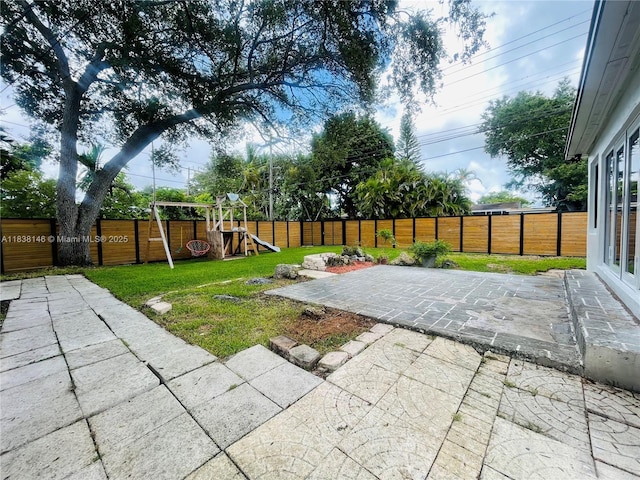 1930 NE 178th St, North Miami Beach, FL 33162 - fenced backyard featuring a patio and a playground