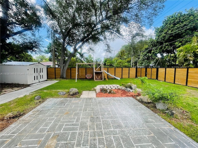 1930 NE 178th St, North Miami Beach, FL 33162 - fenced backyard featuring a playground and a patio