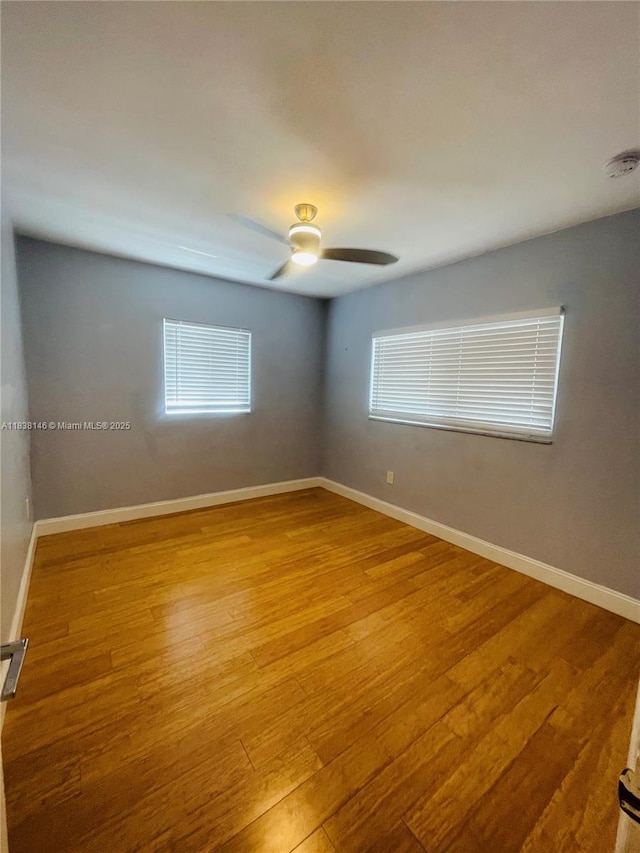 1930 NE 178th St, North Miami Beach, FL 33162 - unfurnished room with a smoke detector, wood finished floors, plenty of natural light, and a ceiling fan