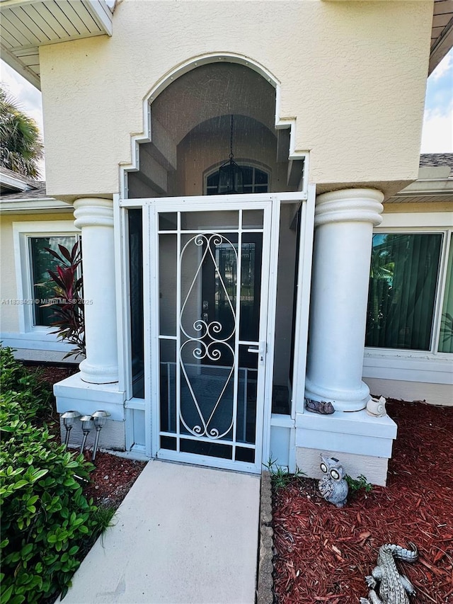 property entrance with stucco siding