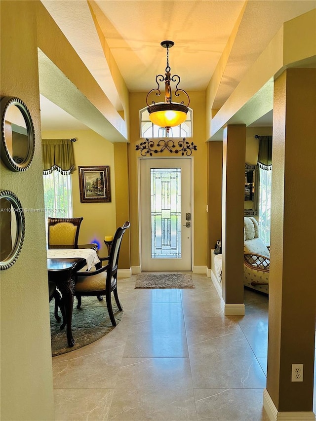 foyer entrance featuring healthy amount of natural light and concrete floors