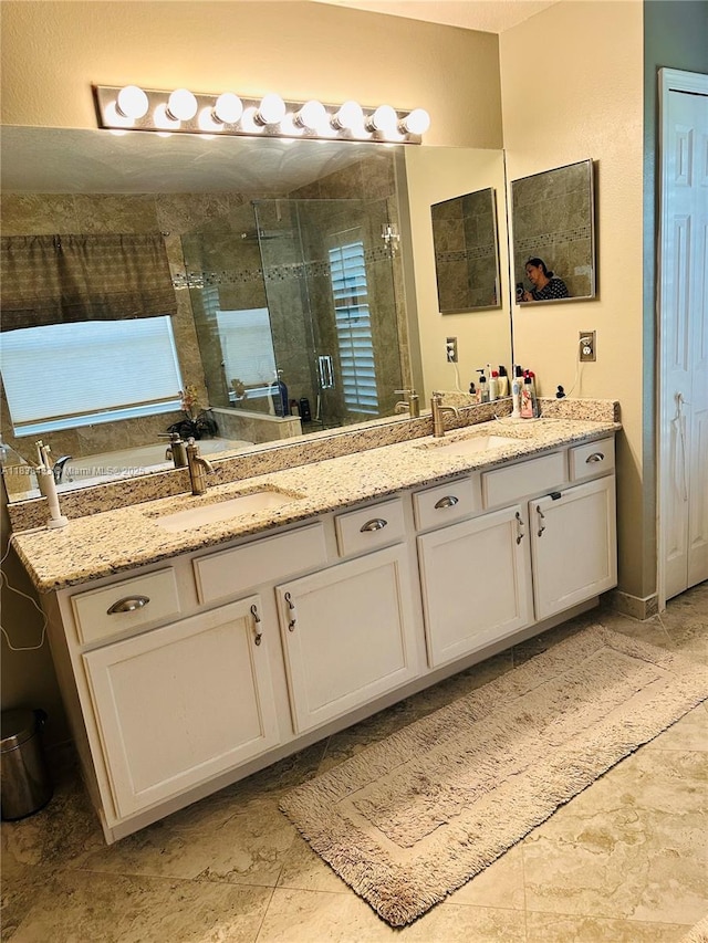 bathroom with double vanity and a stall shower