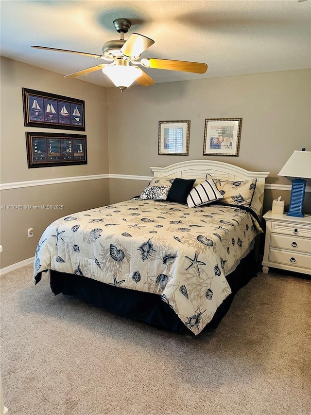 carpeted bedroom featuring a ceiling fan and baseboards