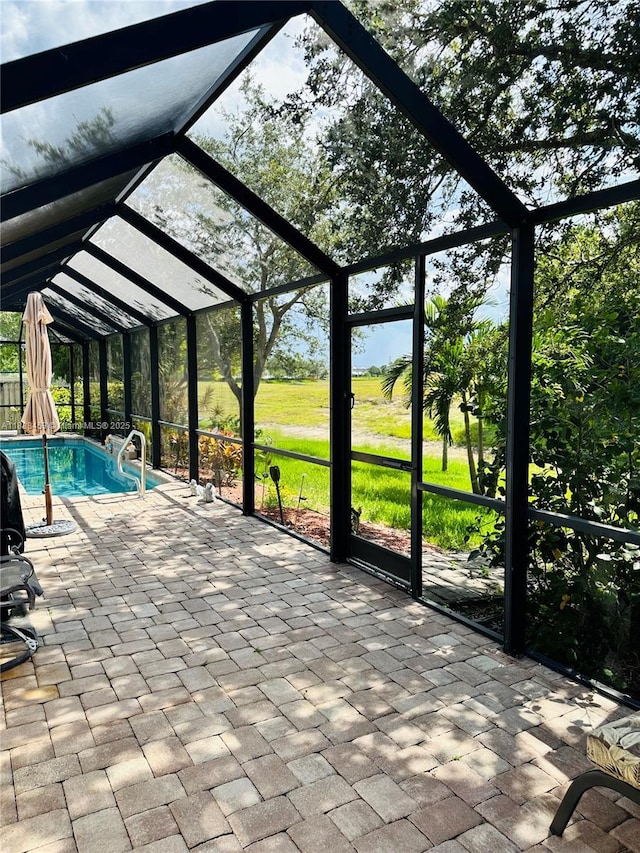 outdoor pool with a lanai, a patio area, and a yard