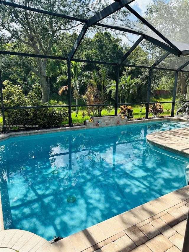 swimming pool featuring glass enclosure