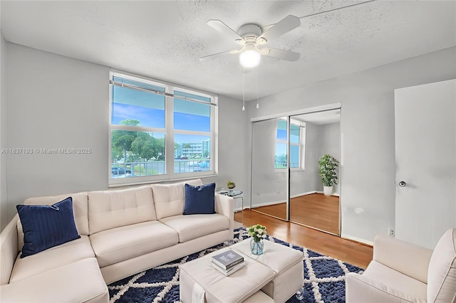 7684 NW 18th St Unit 202, Margate, FL 33063 - living room featuring a ceiling fan, wood finished floors, and a textured ceiling