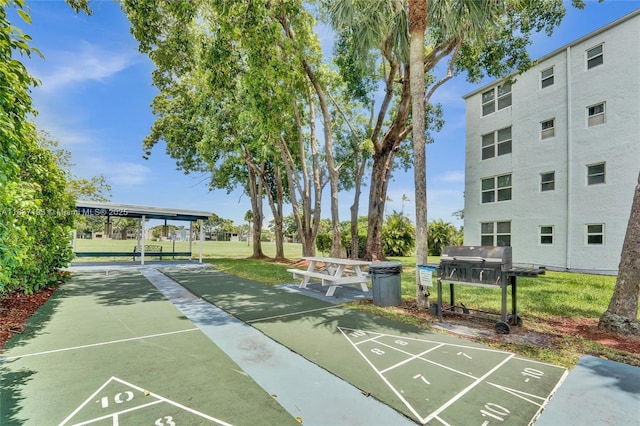 7684 NW 18th St Unit 202, Margate, FL 33063 - surrounding community with shuffleboard and a yard