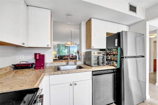 7684 NW 18th St Unit 202, Margate, FL 33063 - kitchen featuring appliances with stainless steel finishes, light tile patterned flooring, white cabinets, and light countertops