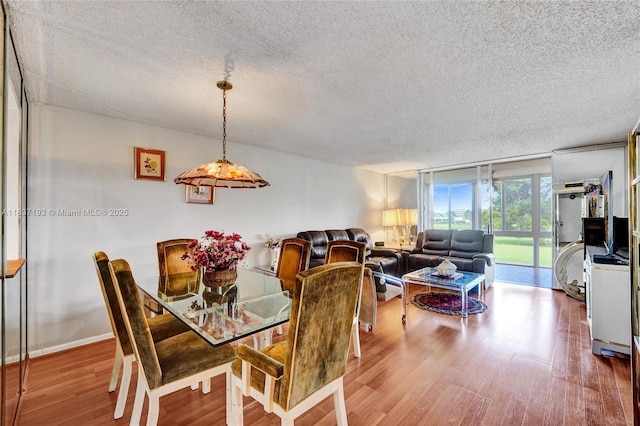 7684 NW 18th St Unit 202, Margate, FL 33063 - dining area with a textured ceiling and wood finished floors