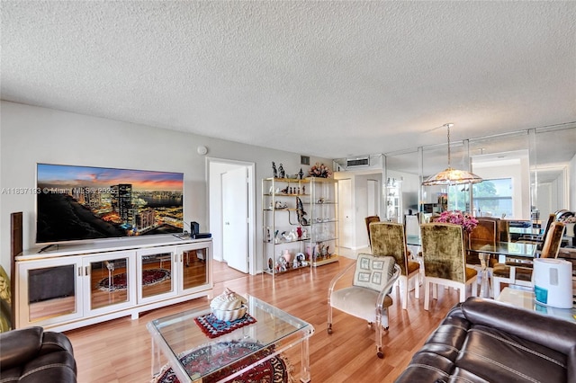 7684 NW 18th St Unit 202, Margate, FL 33063 - living area with a textured ceiling and wood finished floors
