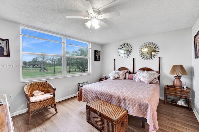 7684 NW 18th St Unit 202, Margate, FL 33063 - bedroom featuring a textured ceiling, wood finished floors, and ceiling fan