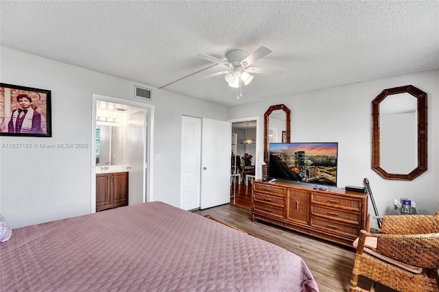 7684 NW 18th St Unit 202, Margate, FL 33063 - bedroom with dark wood finished floors, a textured ceiling, and a ceiling fan