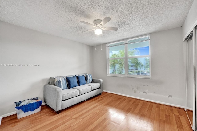 7684 NW 18th St Unit 202, Margate, FL 33063 - living area with light wood finished floors, ceiling fan, and a textured ceiling