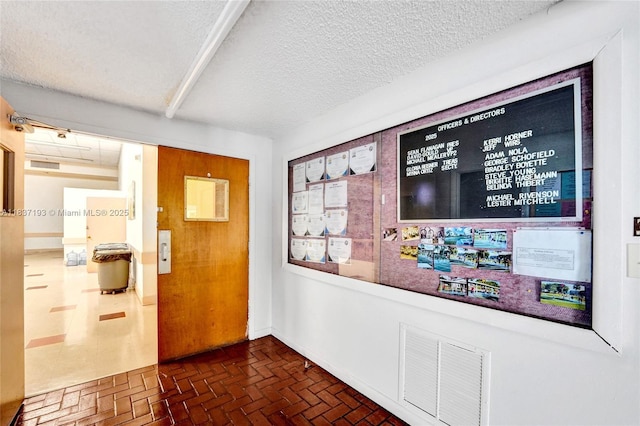 7684 NW 18th St Unit 202, Margate, FL 33063 - hallway with brick patterned flooring and a textured ceiling