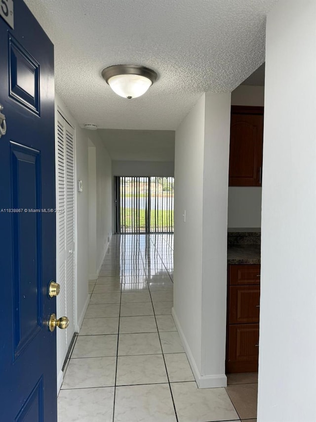 8560 N Sherman Cir Unit 105, Miramar, FL 33025 - hall with a textured ceiling and light tile patterned floors
