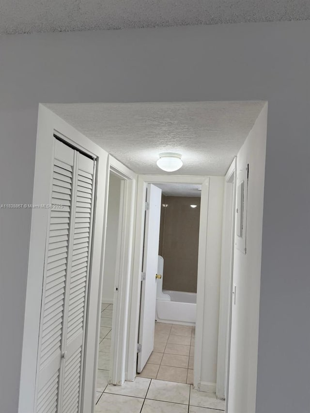 8560 N Sherman Cir Unit 105, Miramar, FL 33025 - hall with a textured ceiling and light tile patterned floors