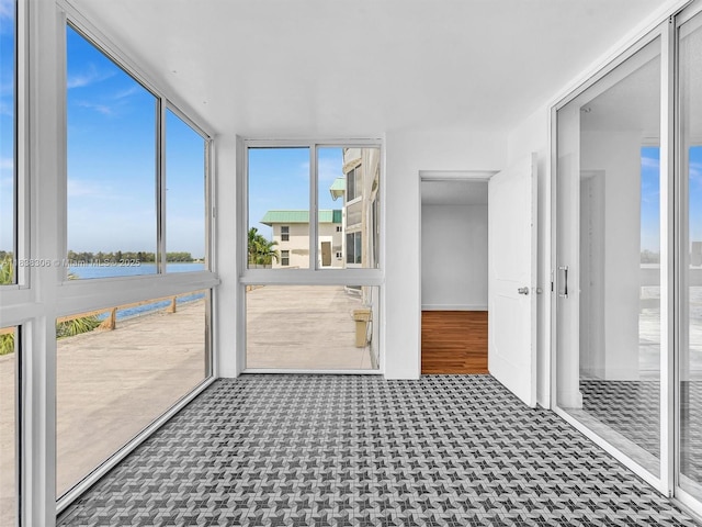 1170 NE 191st St Unit 24, Miami, FL 33179 - unfurnished sunroom with healthy amount of natural light and a water view